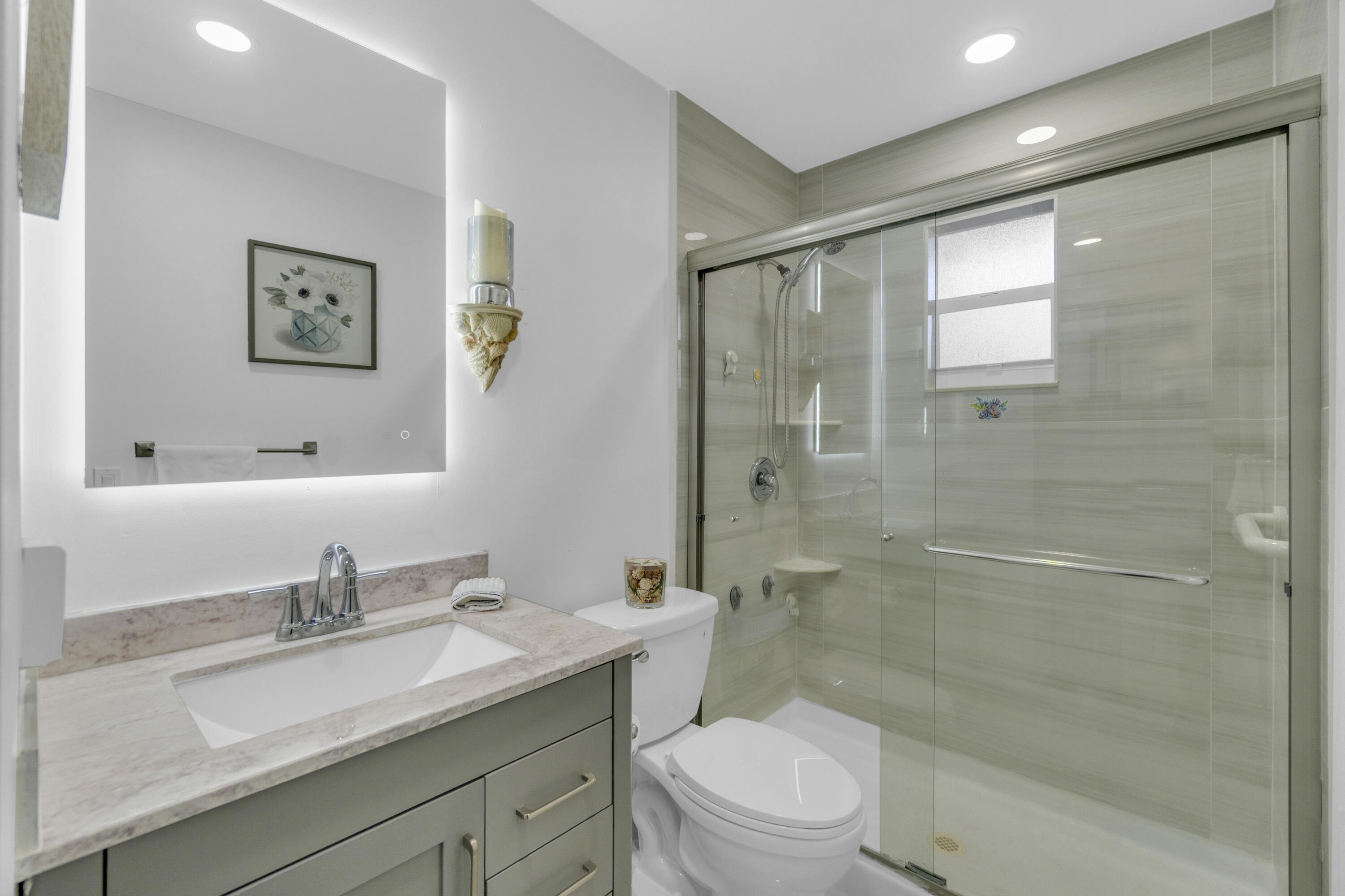 504 Davis Road, Unit 86 Palm Springs, FL 33461 - Photo 13 of 25 a bathroom with a granite countertop sink a toilet and shower
