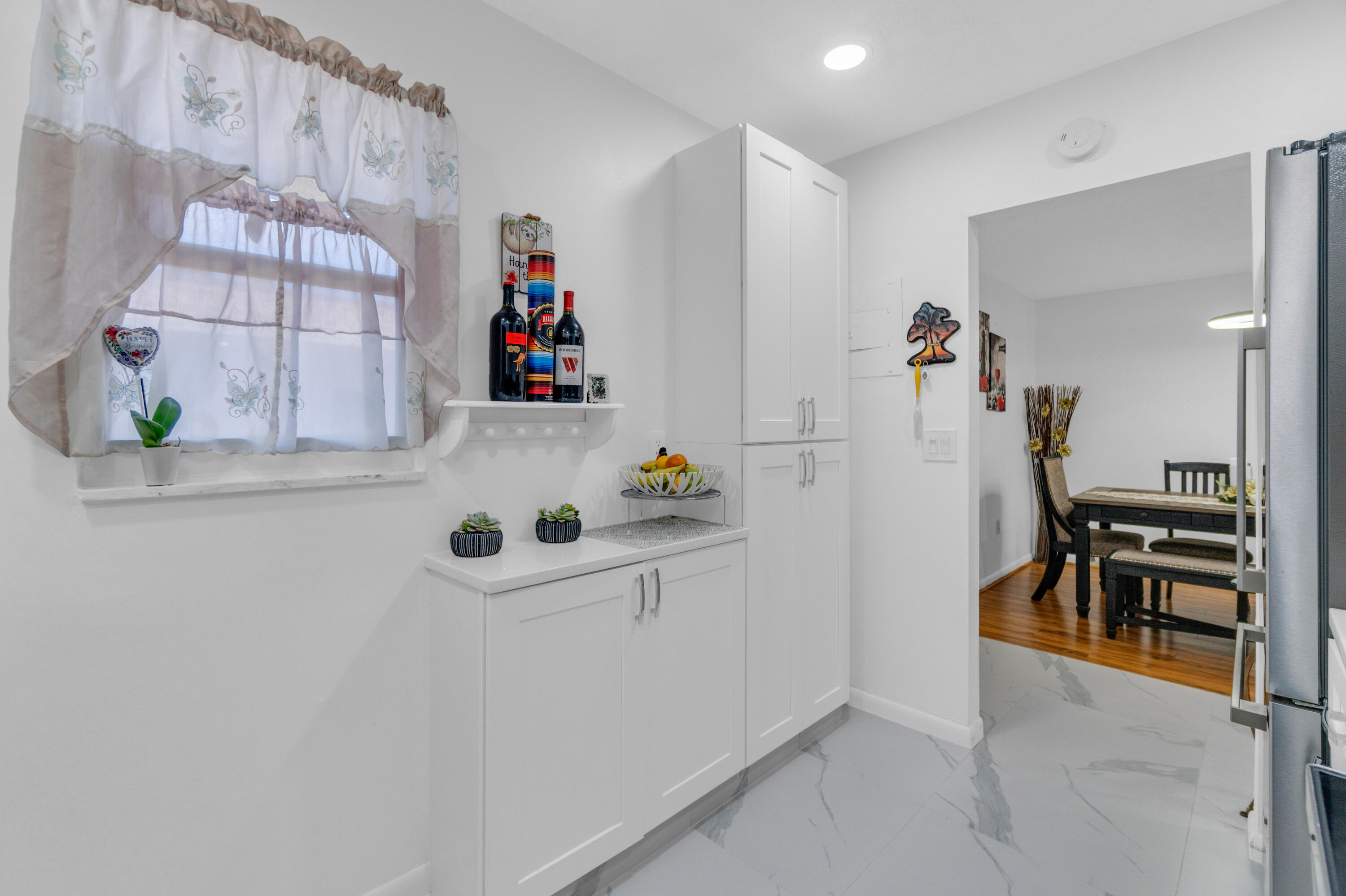 504 Davis Road, Unit 86 Palm Springs, FL 33461 - Photo 2 of 25 walk in closet with wooden floor and cabinets