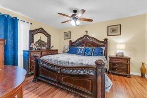 504 Davis Road, Unit 86 Palm Springs, FL 33461 - Photo 24 of 25 a bedroom with a bed and a chandelier