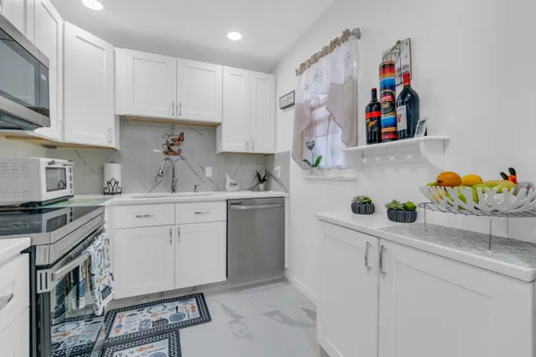 a kitchen with stainless steel appliances granite countertop a sink and cabinets