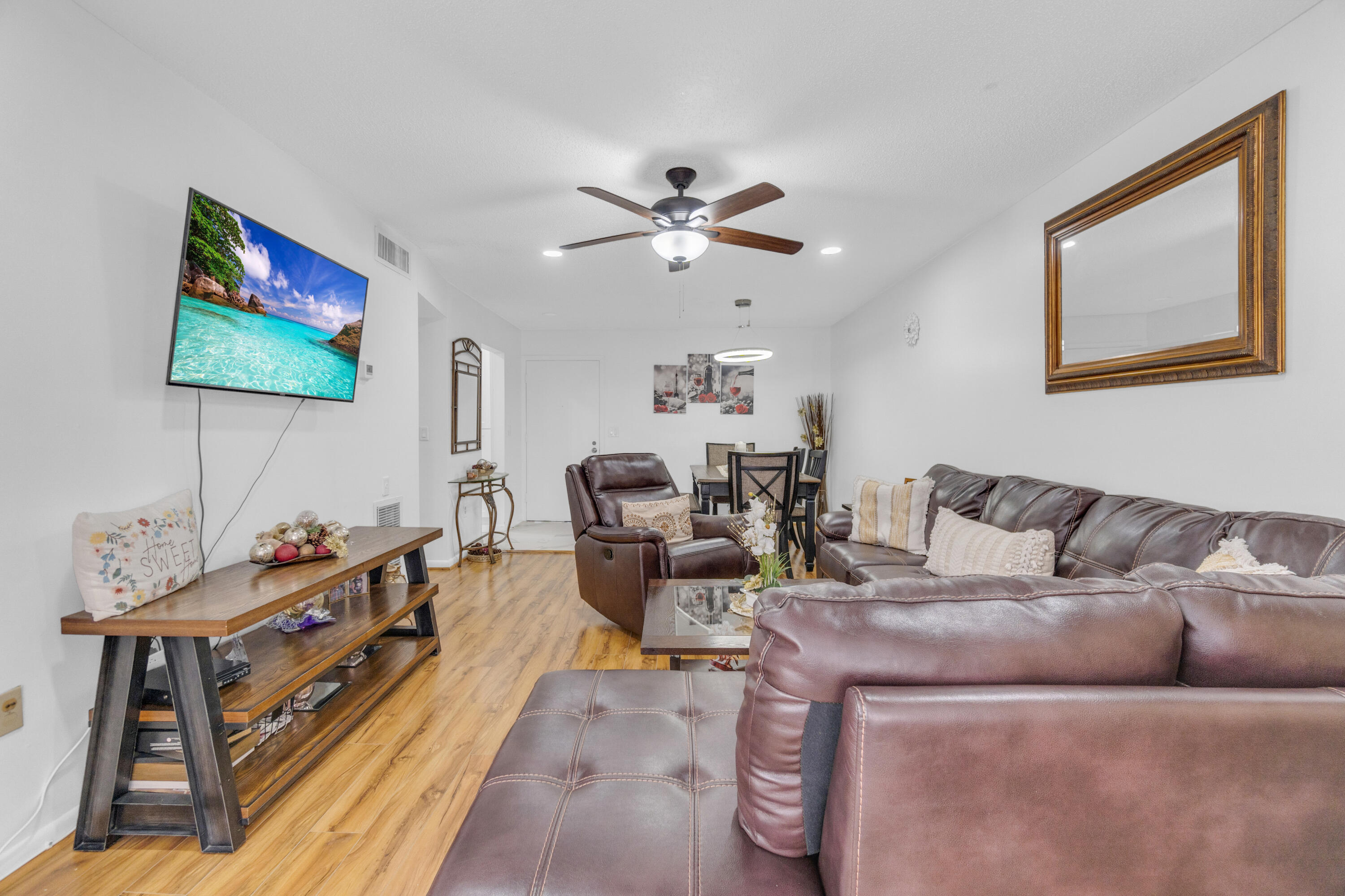 504 Davis Road, Unit 86 Palm Springs, FL 33461 - Photo 5 of 25 a living room with furniture and a flat screen tv