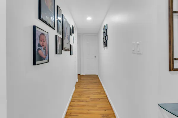 a view of a hallway with paintings on the wall