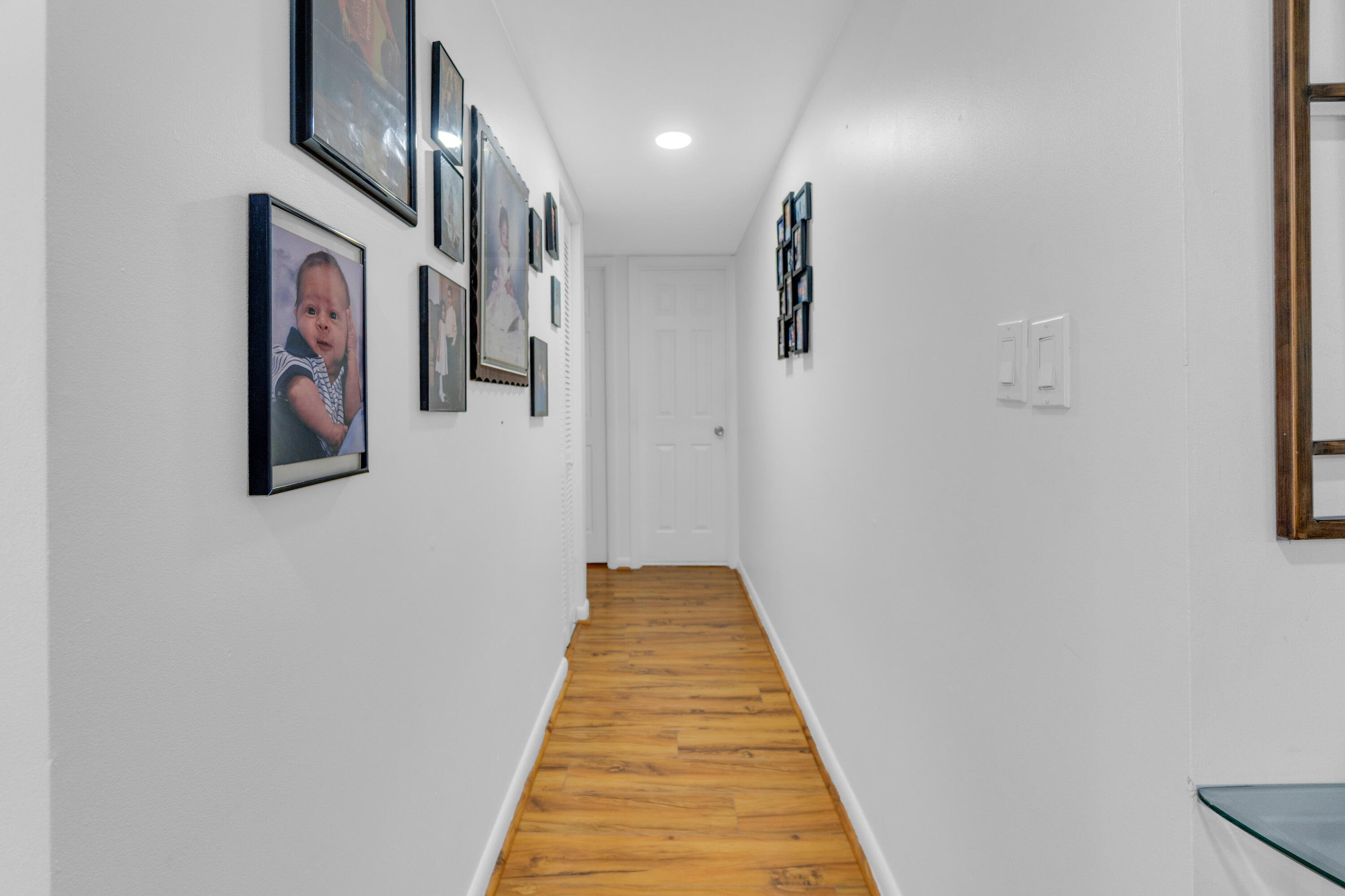 504 Davis Road, Unit 86 Palm Springs, FL 33461 - Photo 8 of 25 a view of a hallway with paintings on the wall