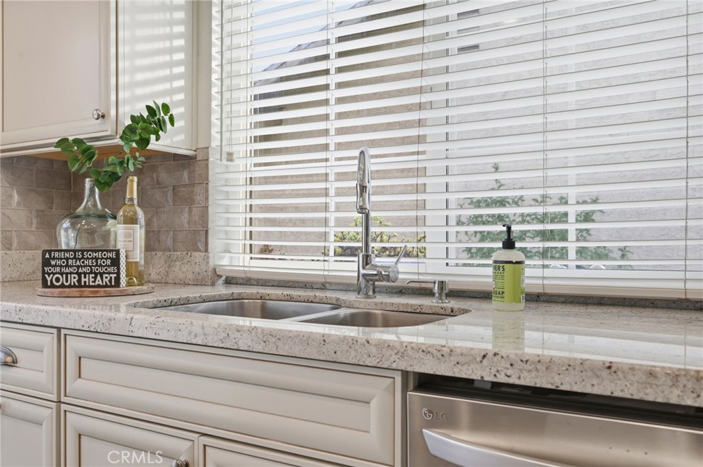 25868 Alegro Drive Valencia, CA 91355 - Photo 11 of 35 a kitchen with a sink and a potted plant
