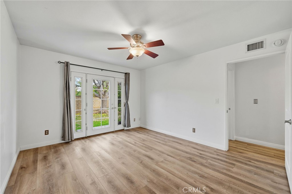25868 Alegro Drive Valencia, CA 91355 - Photo 17 of 35 a view of a room with wooden floor and a ceiling fan