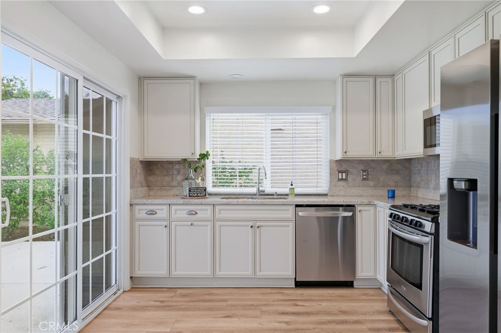 25868 Alegro Drive Valencia, CA 91355 - Photo 8 of 35 a kitchen with stainless steel appliances granite countertop a stove a sink and a refrigerator