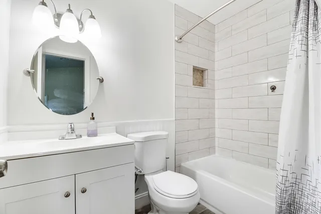 a bathroom with a sink toilet and shower