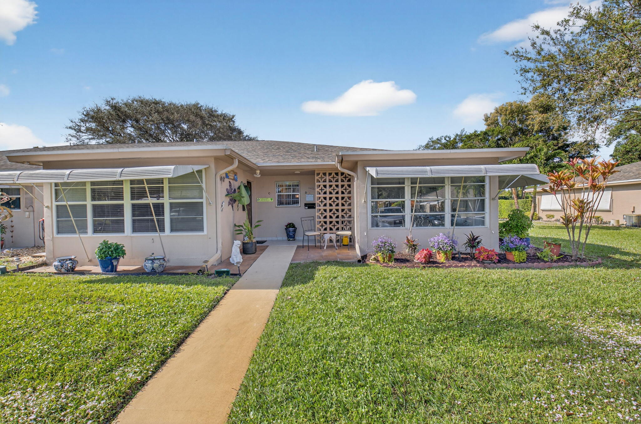 a front view of a house with a yard and porch