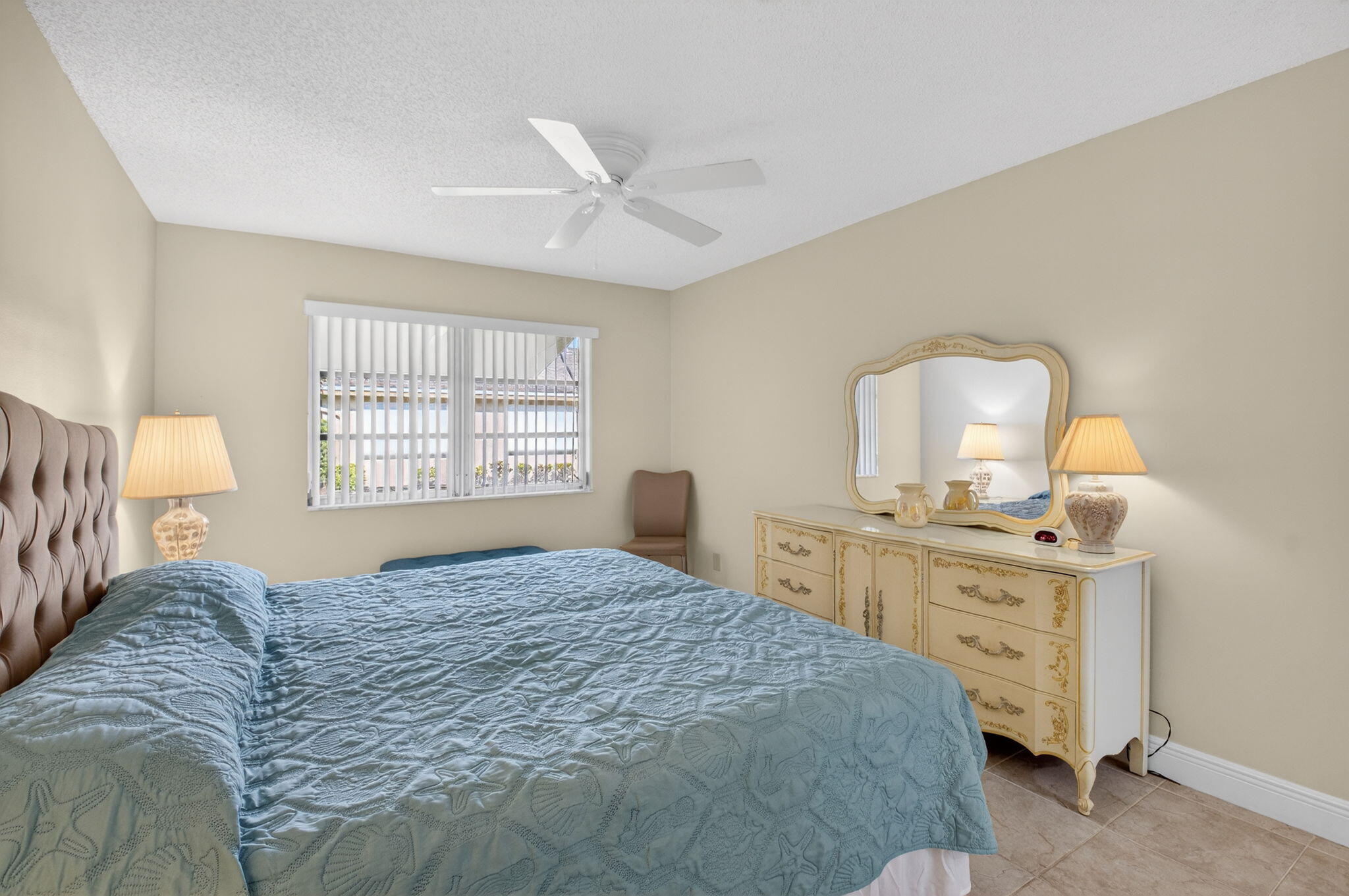 1390 High Point Way Southwest, Unit D Delray Beach, FL 33445 - Photo 15 of 39 a bedroom with a bed and a dresser