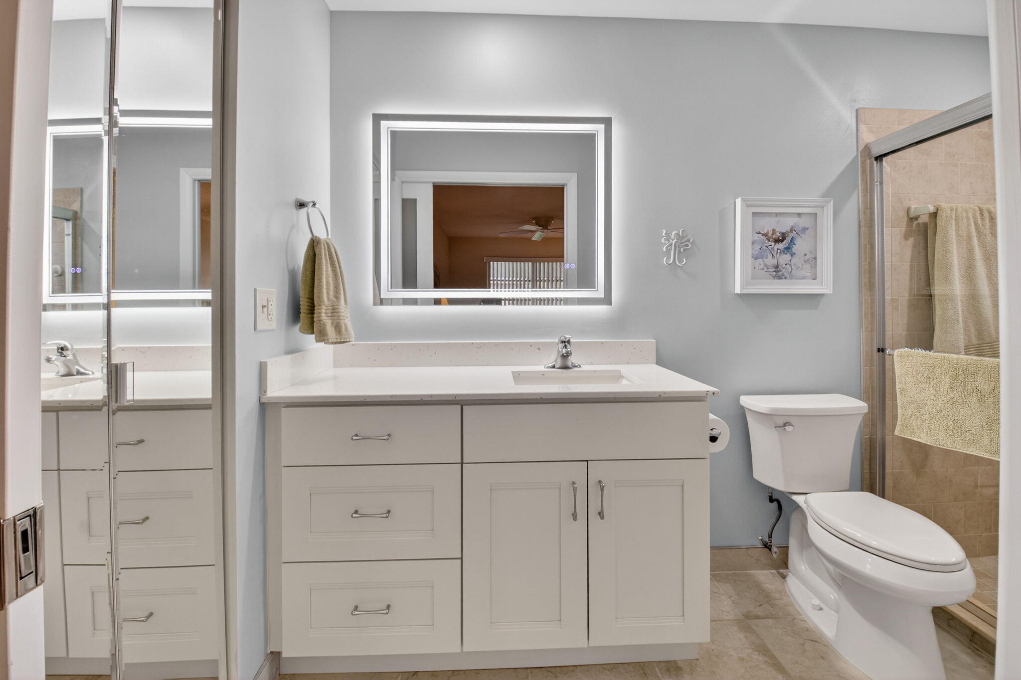 1390 High Point Way Southwest, Unit D Delray Beach, FL 33445 - Photo 16 of 39 a bathroom with a sink vanity mirror and toilet