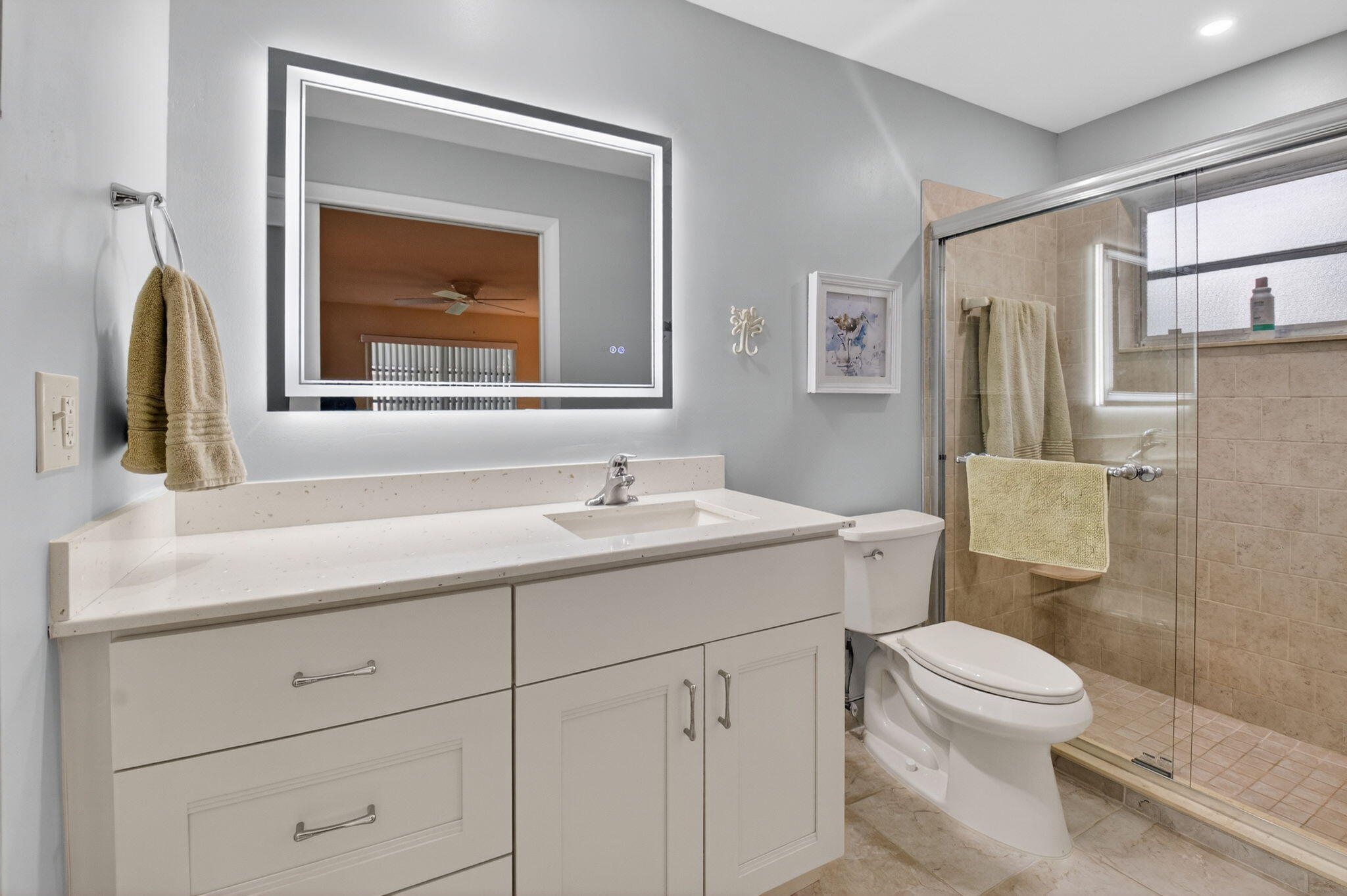 1390 High Point Way Southwest, Unit D Delray Beach, FL 33445 - Photo 17 of 39 a bathroom with a toilet sink vanity and mirror