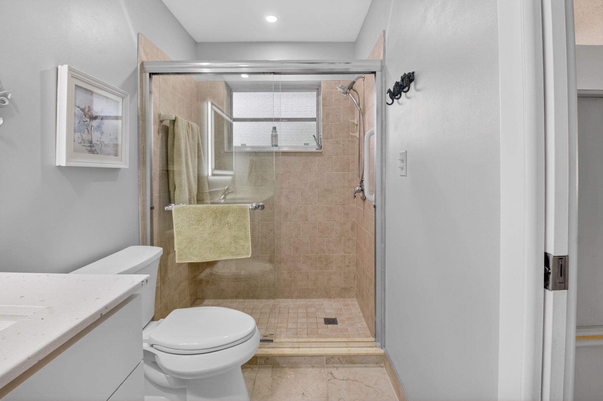 1390 High Point Way Southwest, Unit D Delray Beach, FL 33445 - Photo 18 of 39 a bathroom with a toilet and a shower