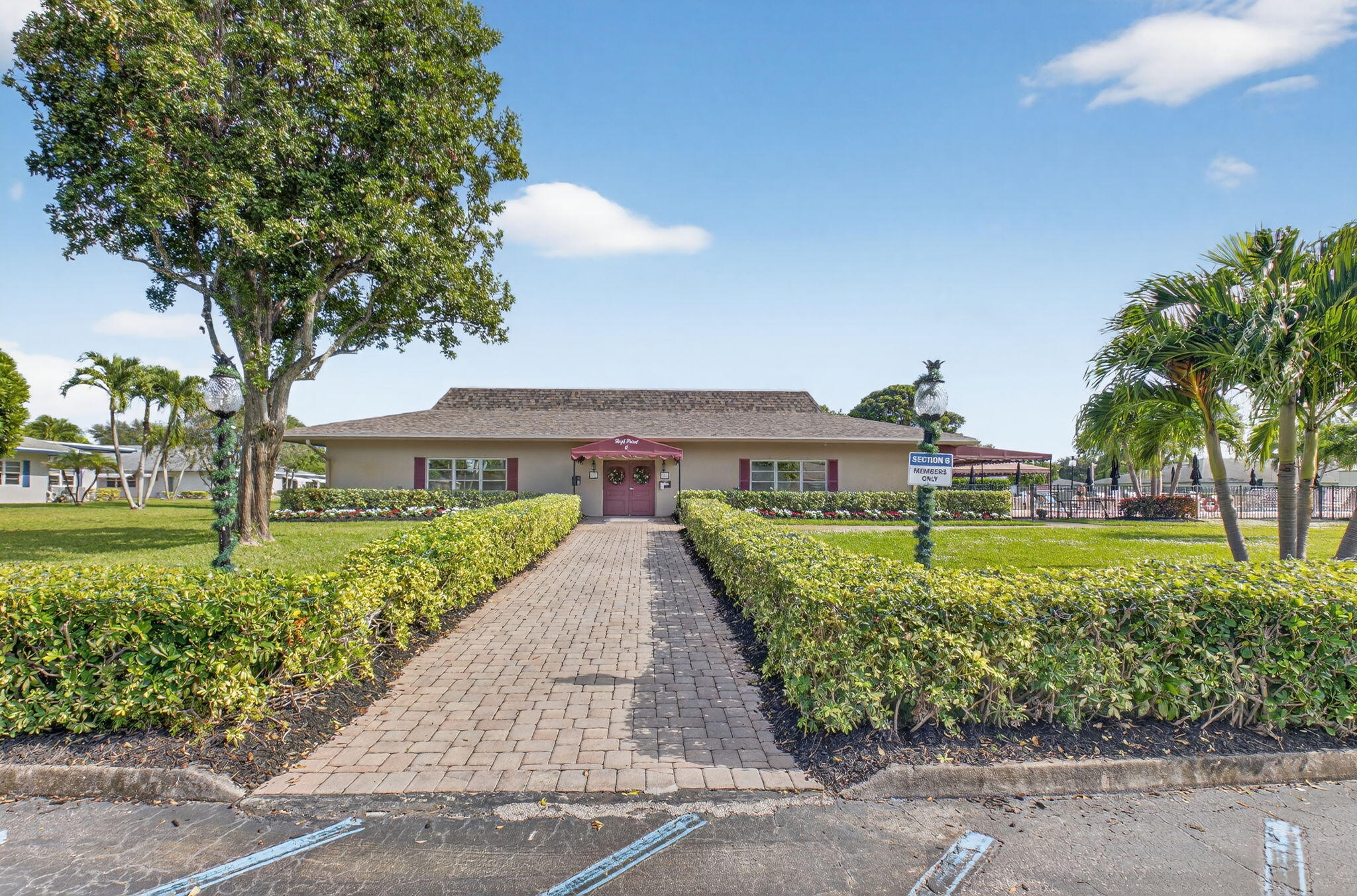1390 High Point Way Southwest, Unit D Delray Beach, FL 33445 - Photo 24 of 39 a front view of a house with a yard and fountain