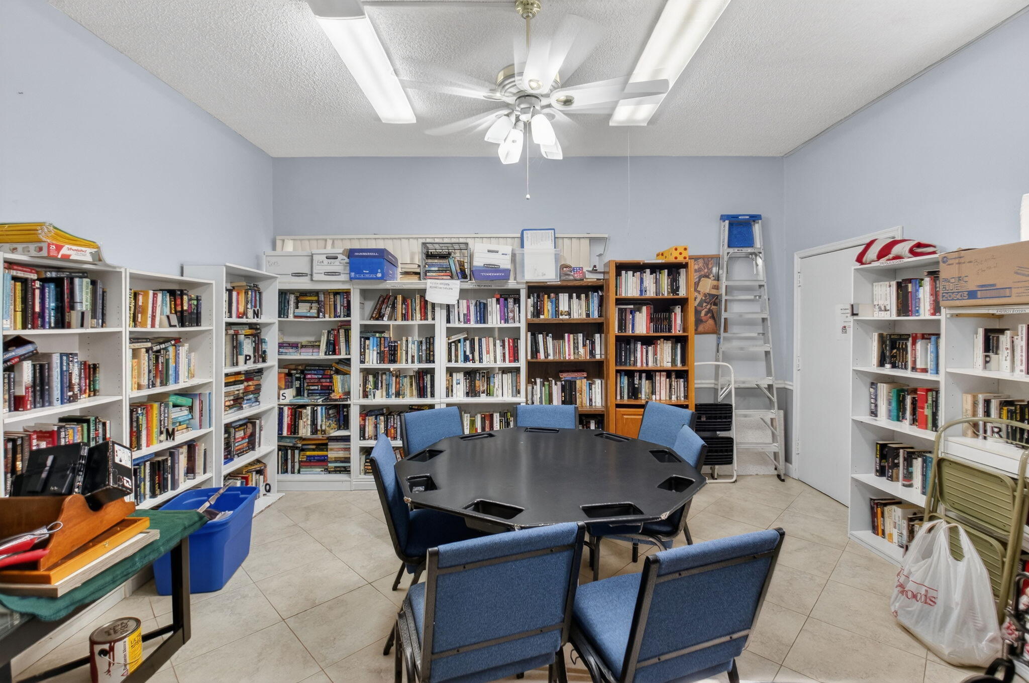 1390 High Point Way Southwest, Unit D Delray Beach, FL 33445 - Photo 26 of 39 a view of a livingroom with workspace and a book shelf
