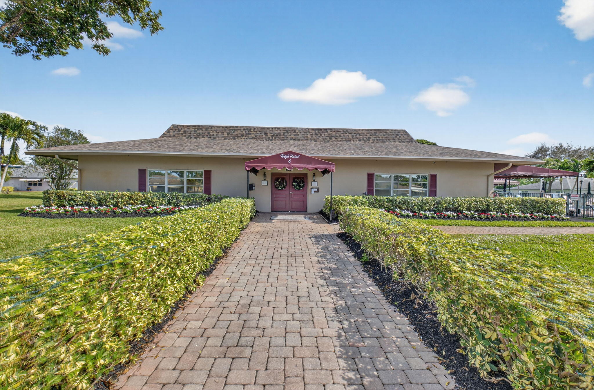 1390 High Point Way Southwest, Unit D Delray Beach, FL 33445 - Photo 27 of 39 a front view of a house with a garden