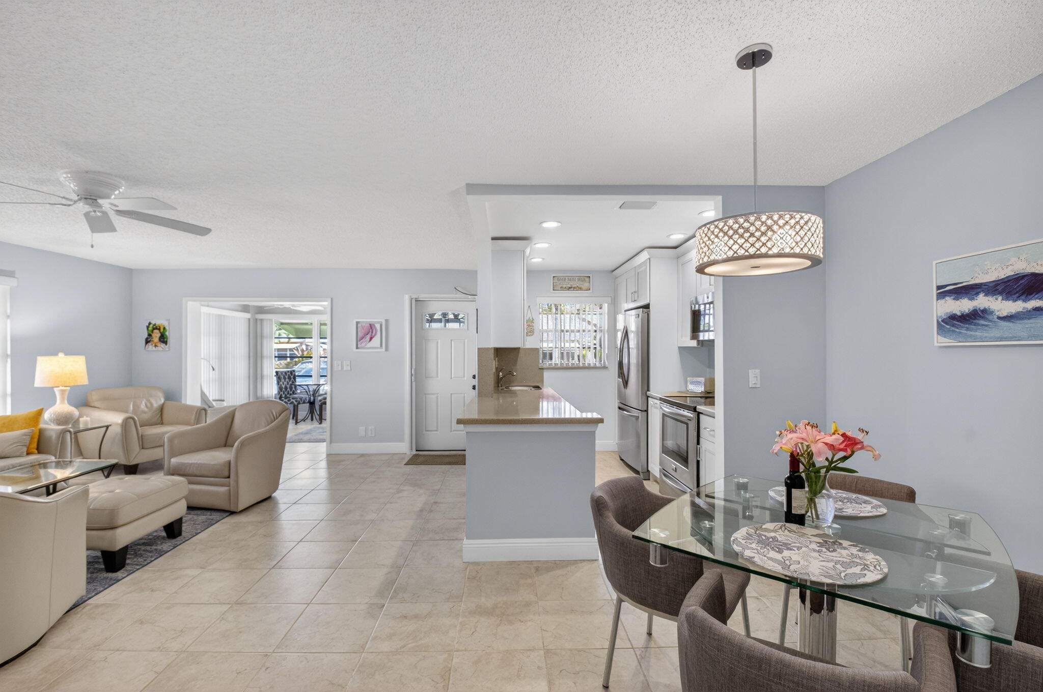 1390 High Point Way Southwest, Unit D Delray Beach, FL 33445 - Photo 6 of 39 a living room with furniture and a chandelier