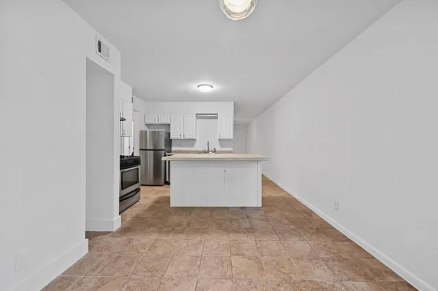 a view of kitchen with refrigerator sink and microwave