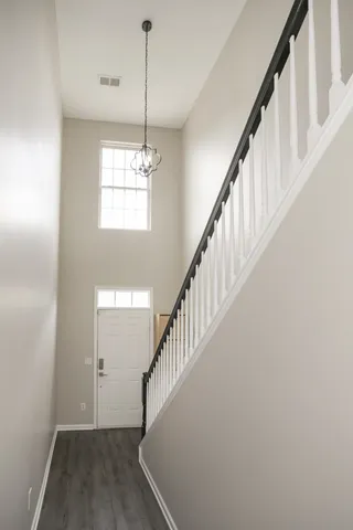 a view of entryway and hall with wooden floor
