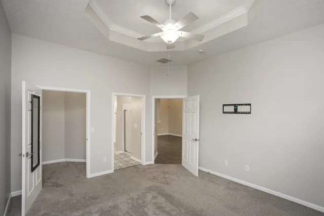an empty room with fan and entrance