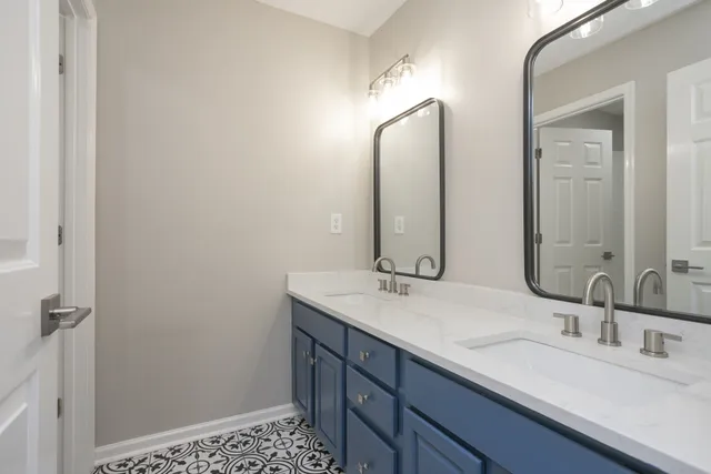a bathroom with a double vanity sink and a mirror