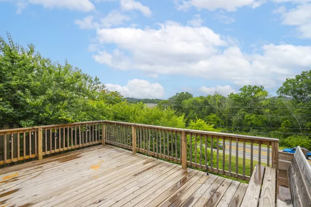 a view of a deck with wooden floor and fence