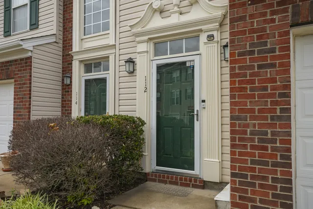 a view of a house with a potted plant and a potted plant
