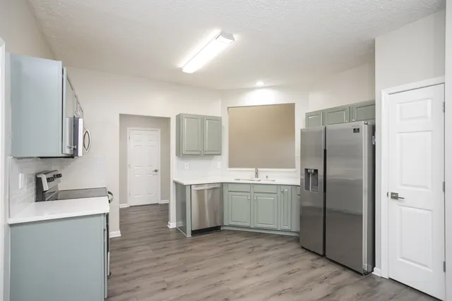 a bathroom with a tub sink and mirror