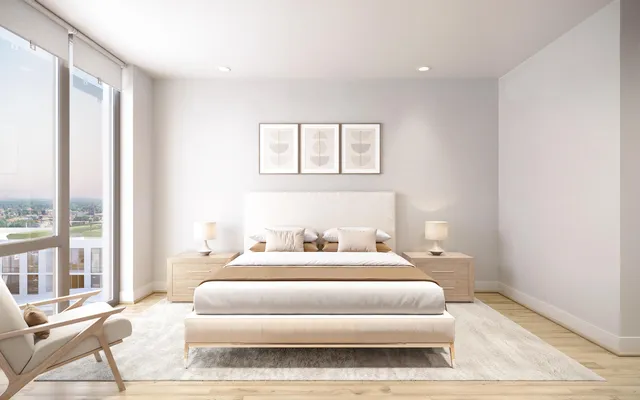 a bedroom with a bed and a large window