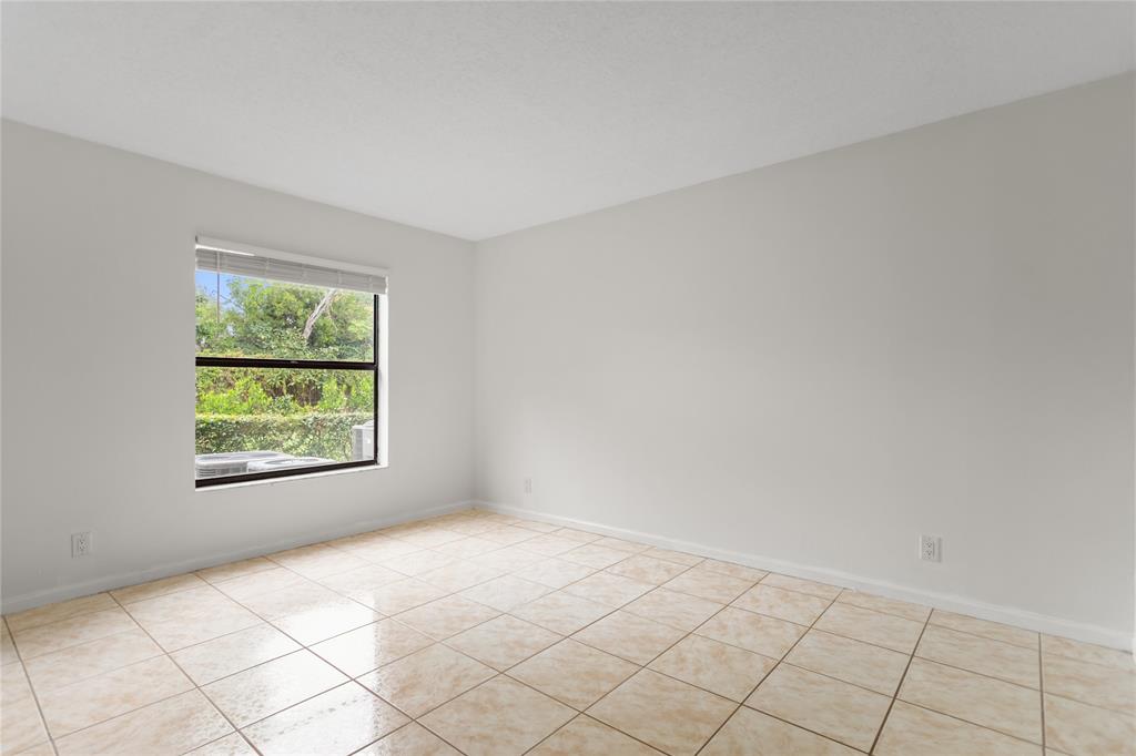 3130 Millwood Terrace, Unit 115 Boca Raton, FL 33431 - Photo 15 of 34 an empty room with windows