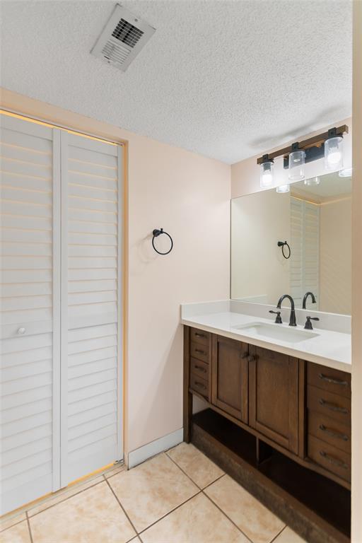 3130 Millwood Terrace, Unit 115 Boca Raton, FL 33431 - Photo 19 of 34 a bathroom with a double vanity sink and mirror
