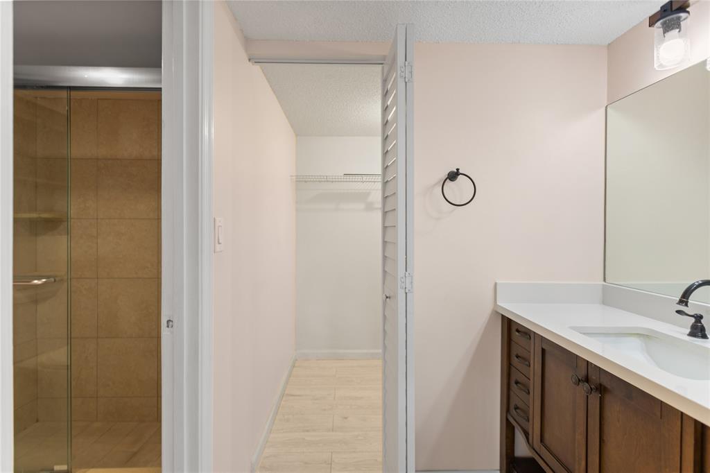 3130 Millwood Terrace, Unit 115 Boca Raton, FL 33431 - Photo 21 of 34 a bathroom with a sink and mirror