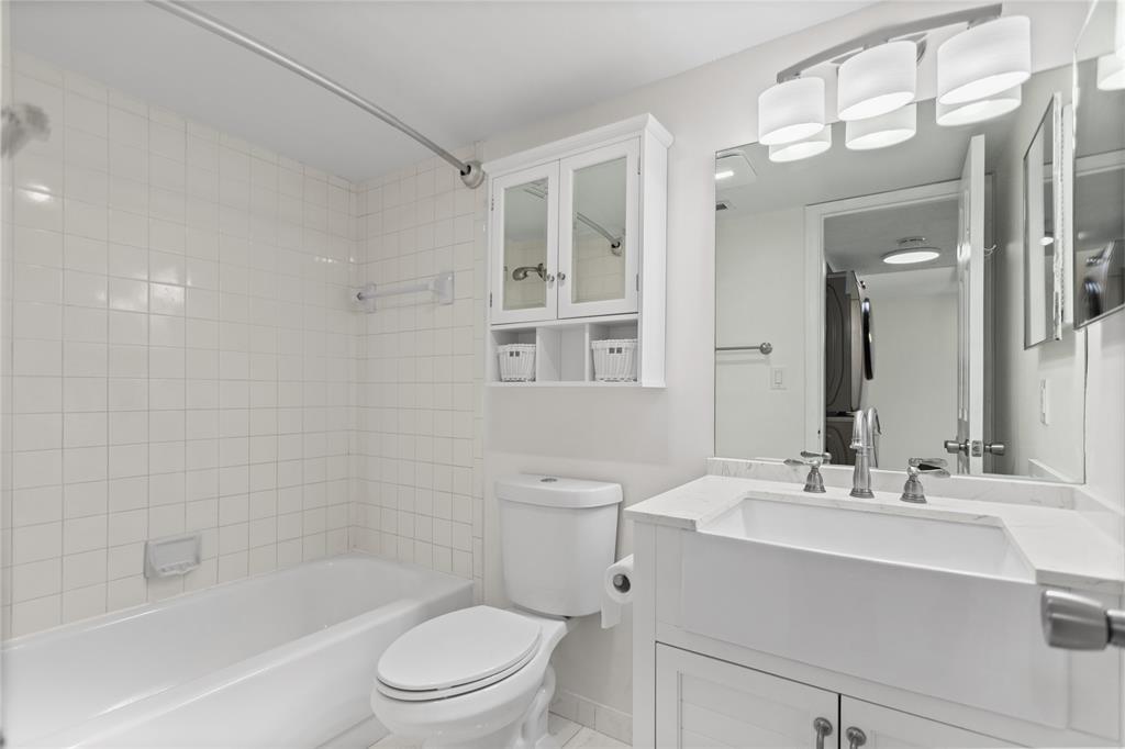 3130 Millwood Terrace, Unit 115 Boca Raton, FL 33431 - Photo 23 of 34 a bathroom with a sink a toilet and shower