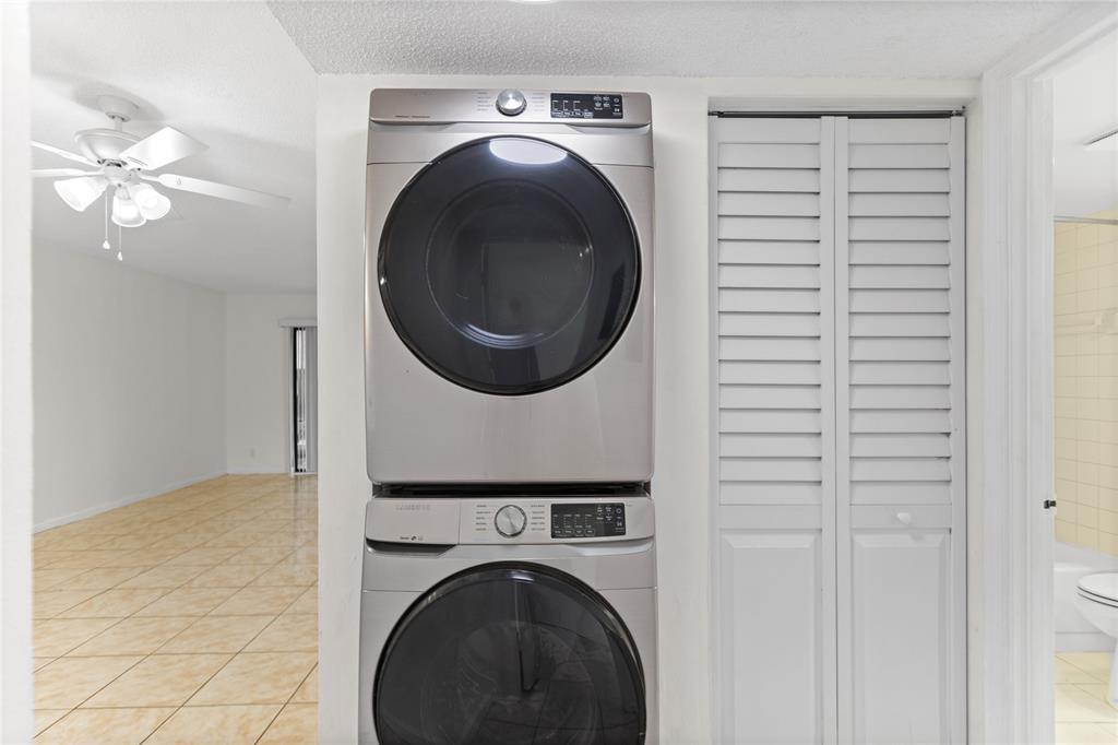 3130 Millwood Terrace, Unit 115 Boca Raton, FL 33431 - Photo 24 of 34 a view of a hallway with washer and dryer