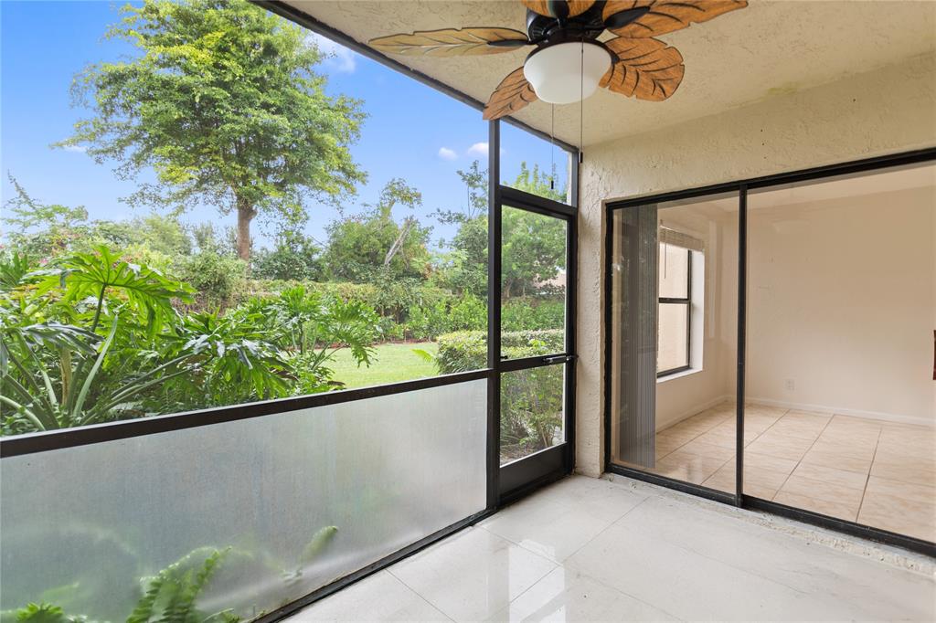 3130 Millwood Terrace, Unit 115 Boca Raton, FL 33431 - Photo 25 of 34 a view of a room with a balcony and ceiling fan