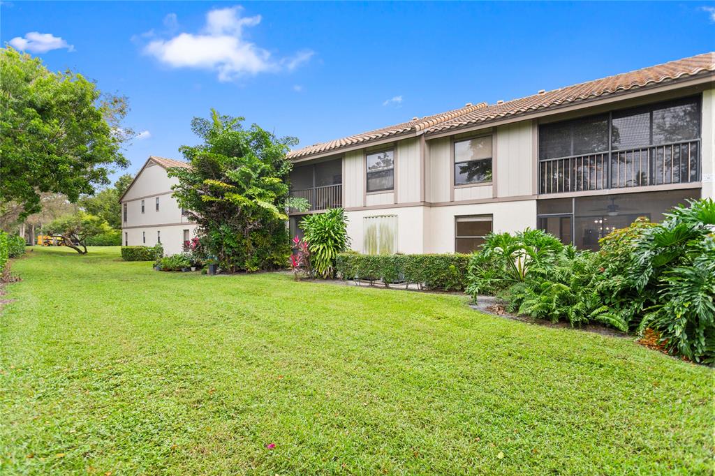 3130 Millwood Terrace, Unit 115 Boca Raton, FL 33431 - Photo 27 of 34 a view of a house with backyard and garden
