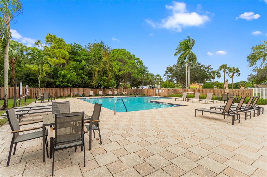 3130 Millwood Terrace, Unit 115 Boca Raton, FL 33431 - Photo 30 of 34 a view of a terrace with furniture and garden