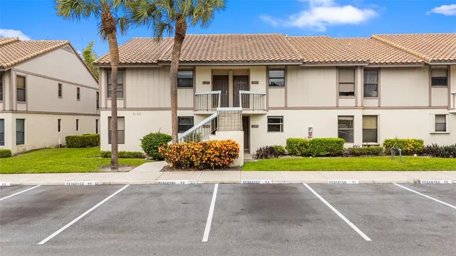 a front view of a house with a garden and plants