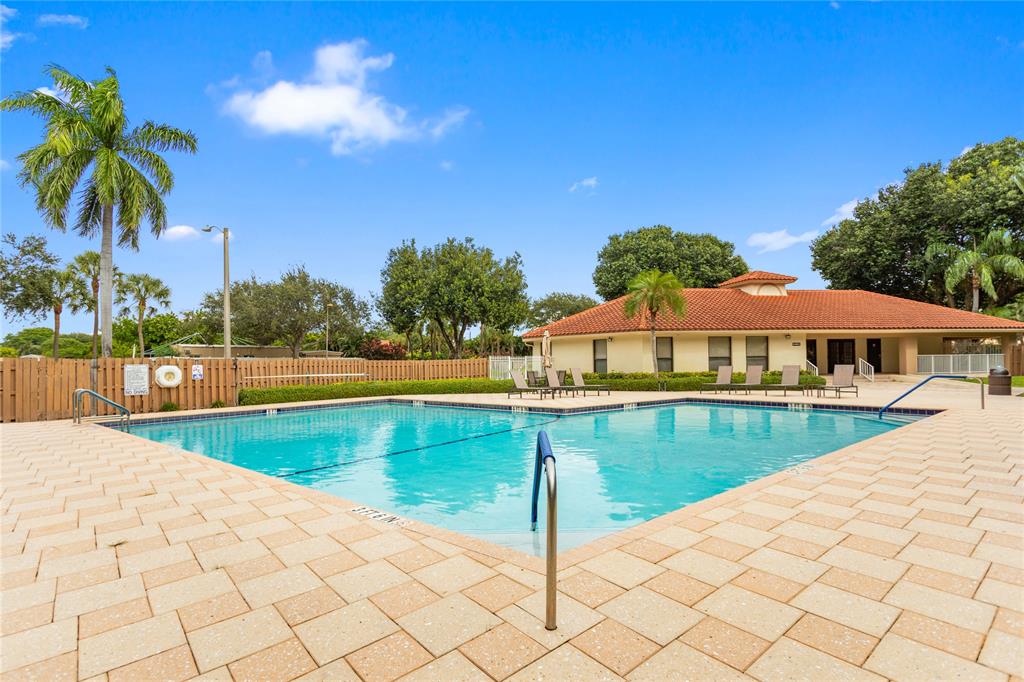 3130 Millwood Terrace, Unit 115 Boca Raton, FL 33431 - Photo 31 of 34 a view of swimming pool with lounge chair