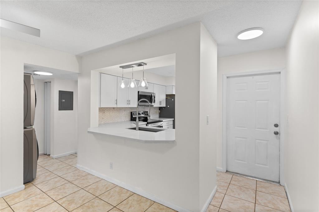 3130 Millwood Terrace, Unit 115 Boca Raton, FL 33431 - Photo 8 of 34 a view of kitchen with refrigerator and window