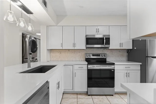 a kitchen with a sink stove and refrigerator