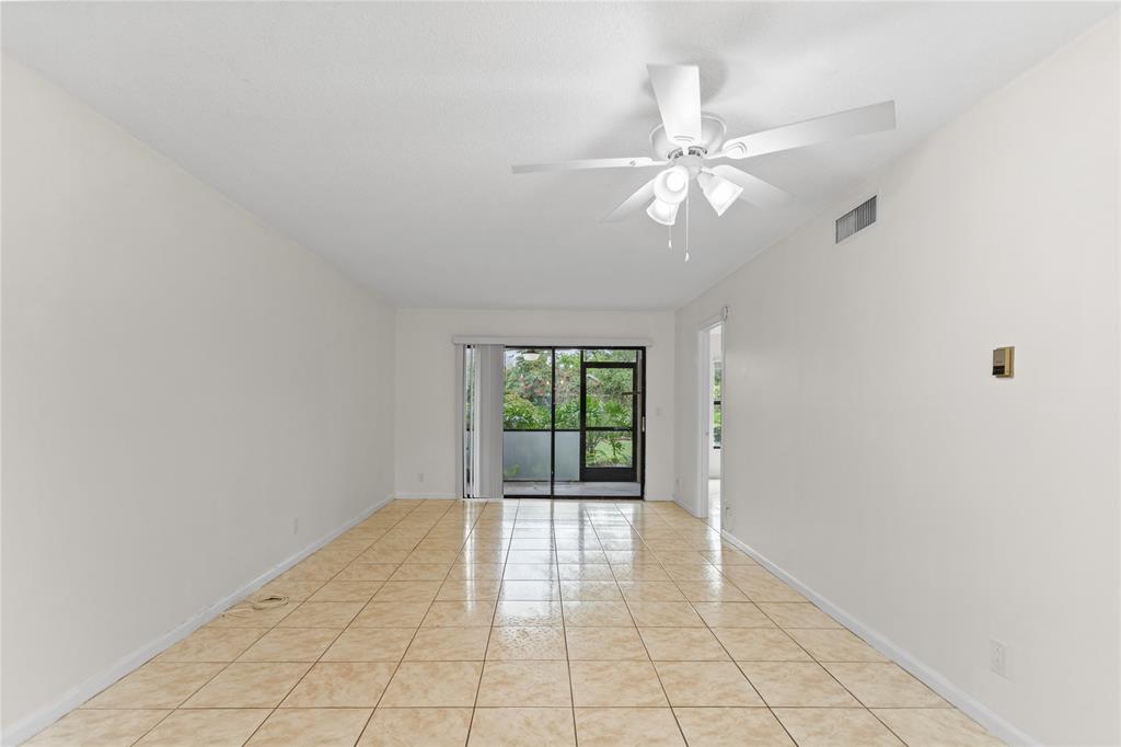 3130 Millwood Terrace, Unit 115 Boca Raton, FL 33431 - Photo 10 of 34 wooden floor in an empty room with a window
