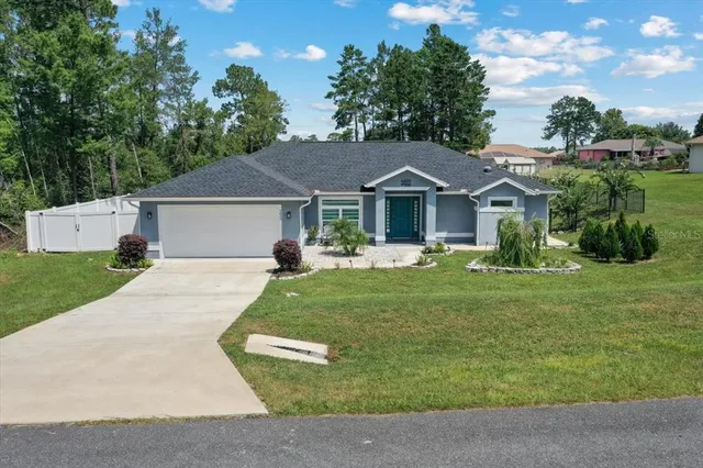 a front view of a house with a garden