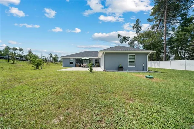 a living room with patio furniture and a garden