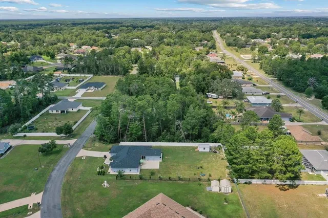 a living room with furniture and a view of kitchen
