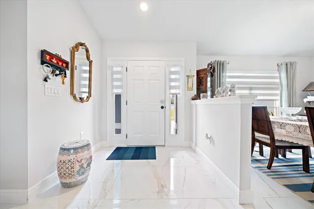 a dining room with furniture and a large window