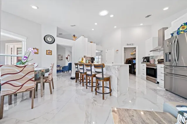 a bedroom with a bed and a flat tv screen on the dresser