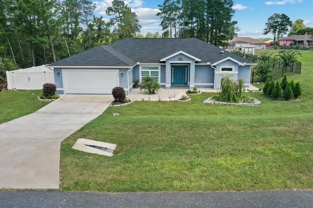 a front view of house with yard and green space