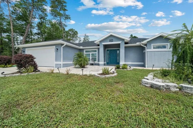 a front view of house with yard and green space