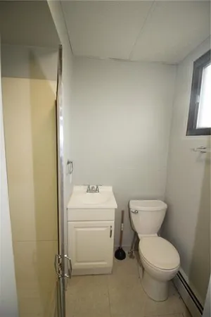 a white toilet sitting next to a bathroom sink