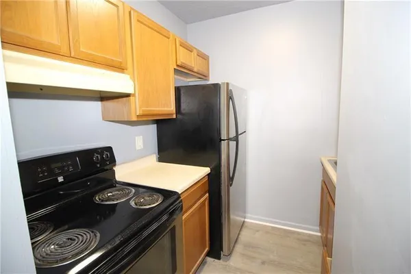 a kitchen with a stove and a refrigerator